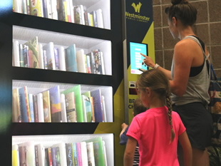 Family using kiosk at City Park Fitness Center