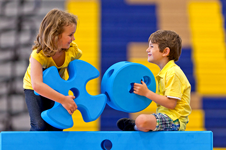 Girl and boy playing with foam shapes